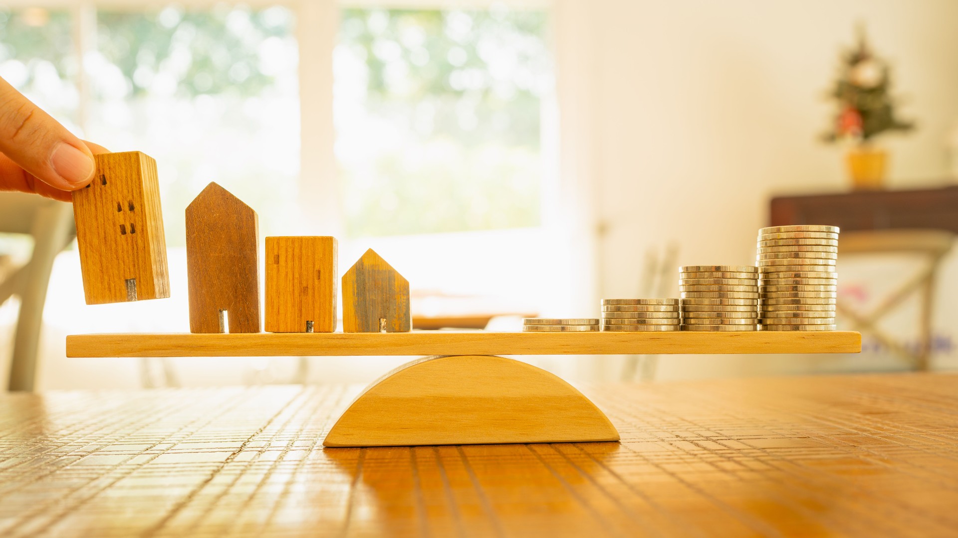Wood house and Coins stack with balance scale. Money management, financial plan, time value of money. Real estate and property agent offer house concepts.