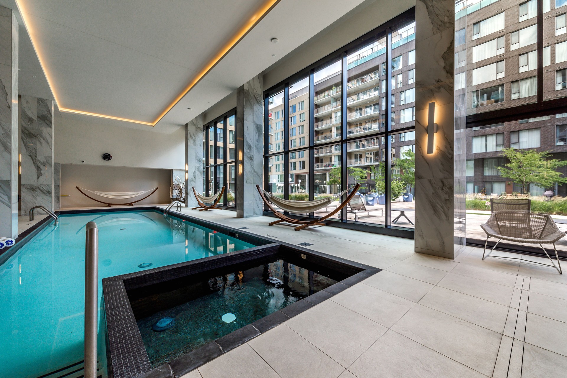 Modern luxury apartment in Montreal Griffintown well staged and furnished with gym, rooftop, terrace, swimming pool, garden, amenities and city views